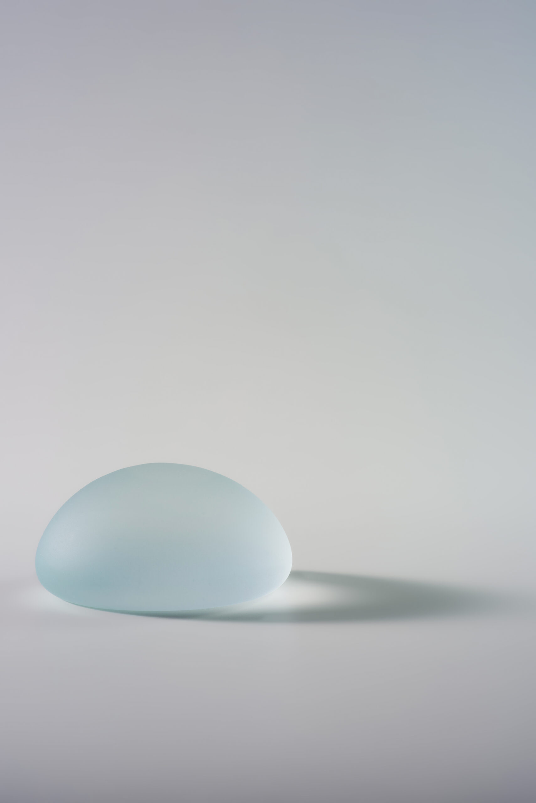Blue Motiva silicone breast implant on a neutral studio background